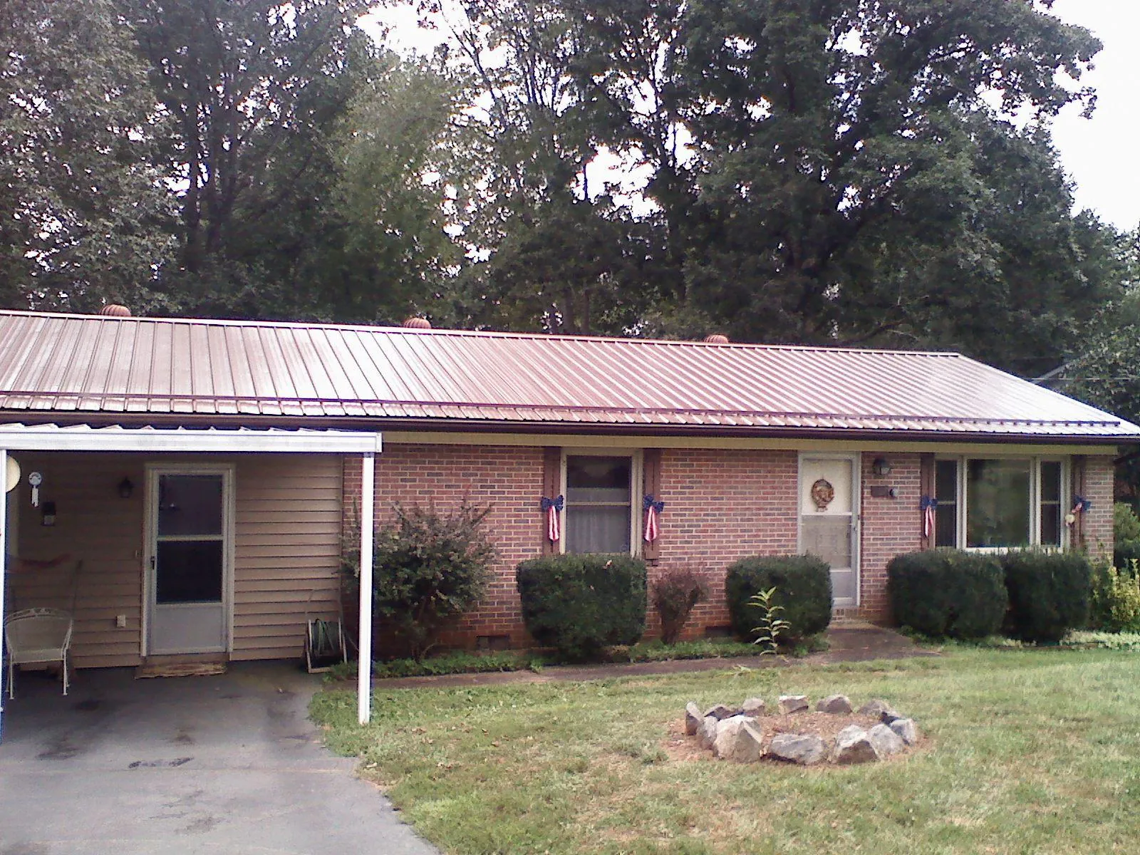Bronze metal roof and carport on a brick ranch home — Roof Repair work by our crew in Thompsontown